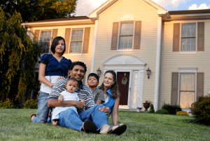 Family of 5 on lawn in front of their home