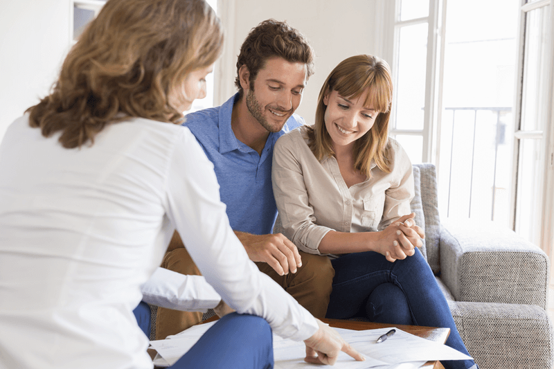 Couple reviewing paperwork with professional (1)